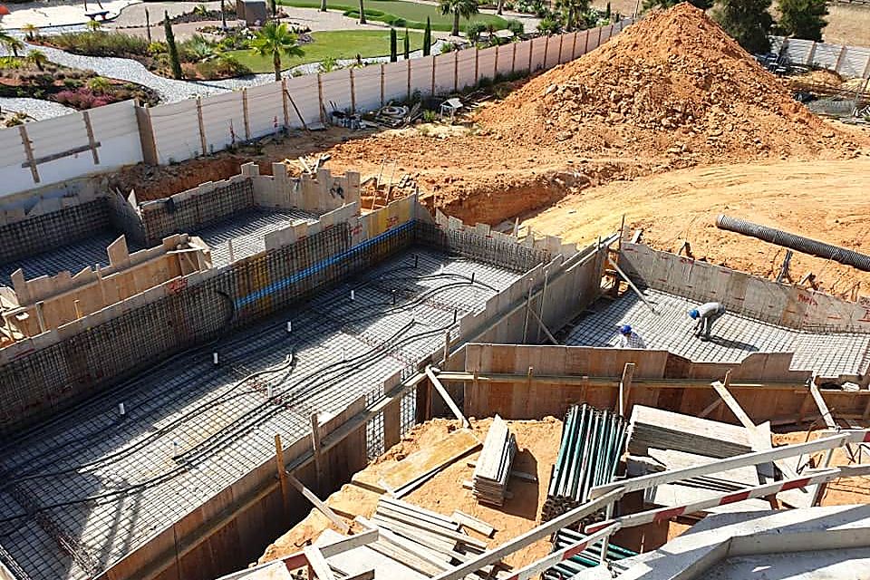 Reinforced concrete structure under construction, with tower crane